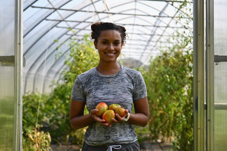 Brooke Bridges harvests heirloom tomatoes